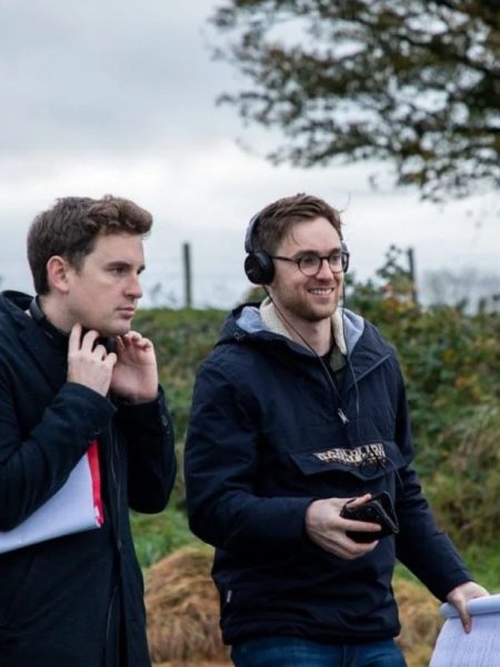 Robert Higgins and Patrick McGivney directing a film in a rural location