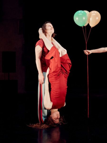 A male and female dancer perform with balloons in Fall and Float