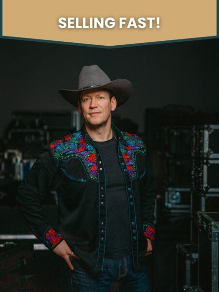 Medium shot of Robert Mizzell wearing a cowboy hat, overlaid with the words "Selling Fast".