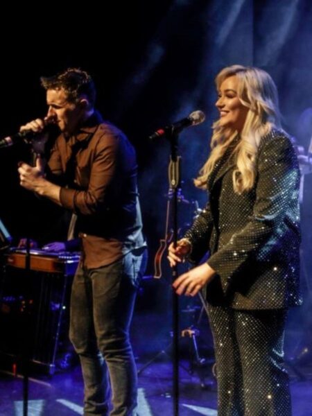 Singers Johnny Brady and Claudia Buckley in performance on a darkened stage in A Night At The Opry.