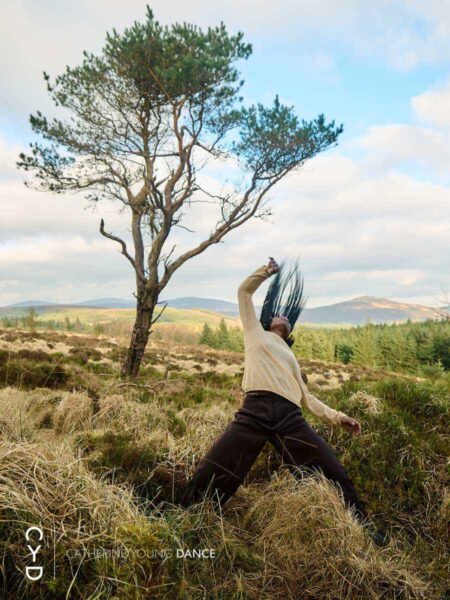 Ciseach - A lone woman performs a contemporary dance in a field with a tree in the background