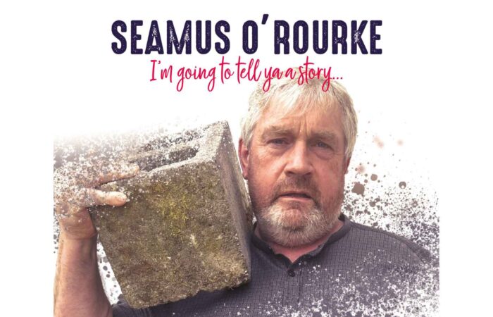 Seamus O'Rourke carrying a cement block on his shoulder in Indigestion