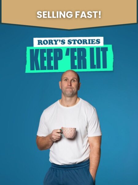 Rory's Stories: Rory stands against a blue backdrop holding a pink mug with a perplexed look on his face.