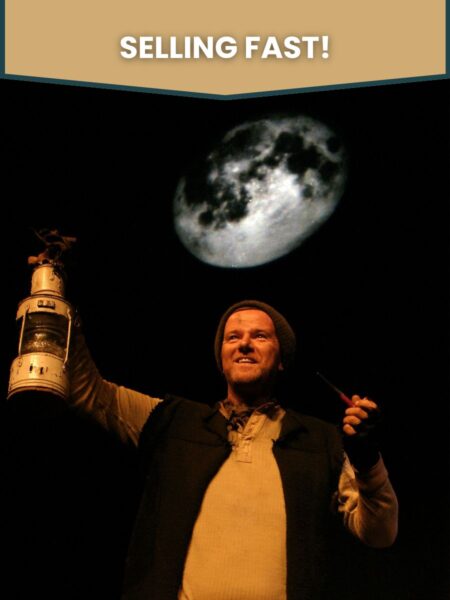 Tom Crean - A man in rugged attire holds a large lantern under a glowing moon, smiling confidently. Text at top reads "SELLING FAST!" Evokes adventure and intrigue.