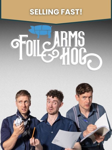 The three members of Foil Arms and Hog stand against a light grey background with exaggerated, puzzled expressions while holding notepads, paper, and pencils, suggesting a comedy writing session. The show's stylized white logo appears above them with a blue pig icon. The words "selling fast" appear on top.