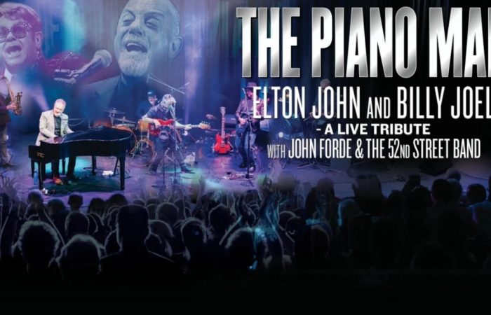 The Piano Man: Elton John and Billy Joel – A Live Tribute, featuring John Forde and the 52nd Street Band performing on stage, with piano, saxophone, guitars and drums, concert lighting, and a cheering audience. Large white lettering displays the show title against a dark blue and black background.