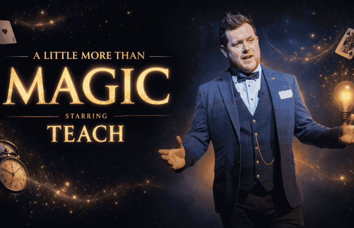 A Little More Than Magic starring Teach. The performer stands on stage in a blue three-piece suit with arms outstretched, surrounded by glowing stars, playing cards, a vintage pocket watch, and a lit lightbulb against a dark, cosmic background. Large gold lettering displays the show title, creating a magical and theatrical atmosphere.